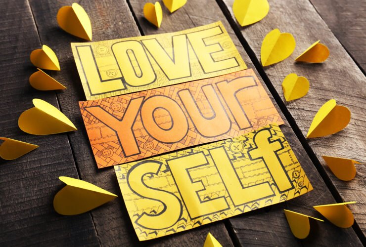 Orange and yellow cards with inscription on wooden background